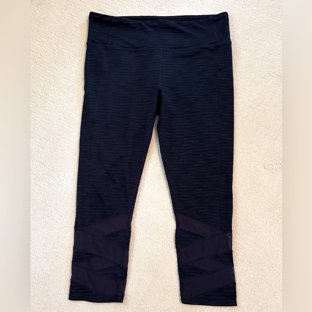 Athleta navy 7/8 leggings with sheer detail.